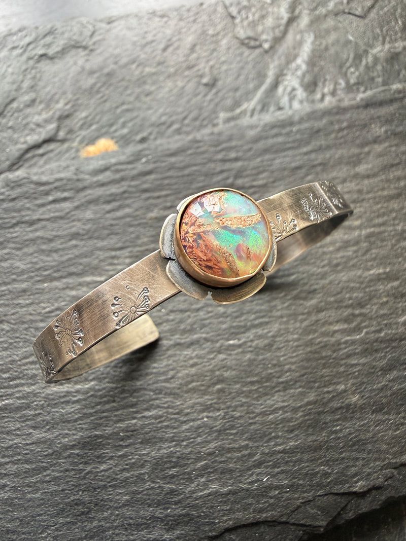 Silver cuff bangle with a round flower opal and stamped band