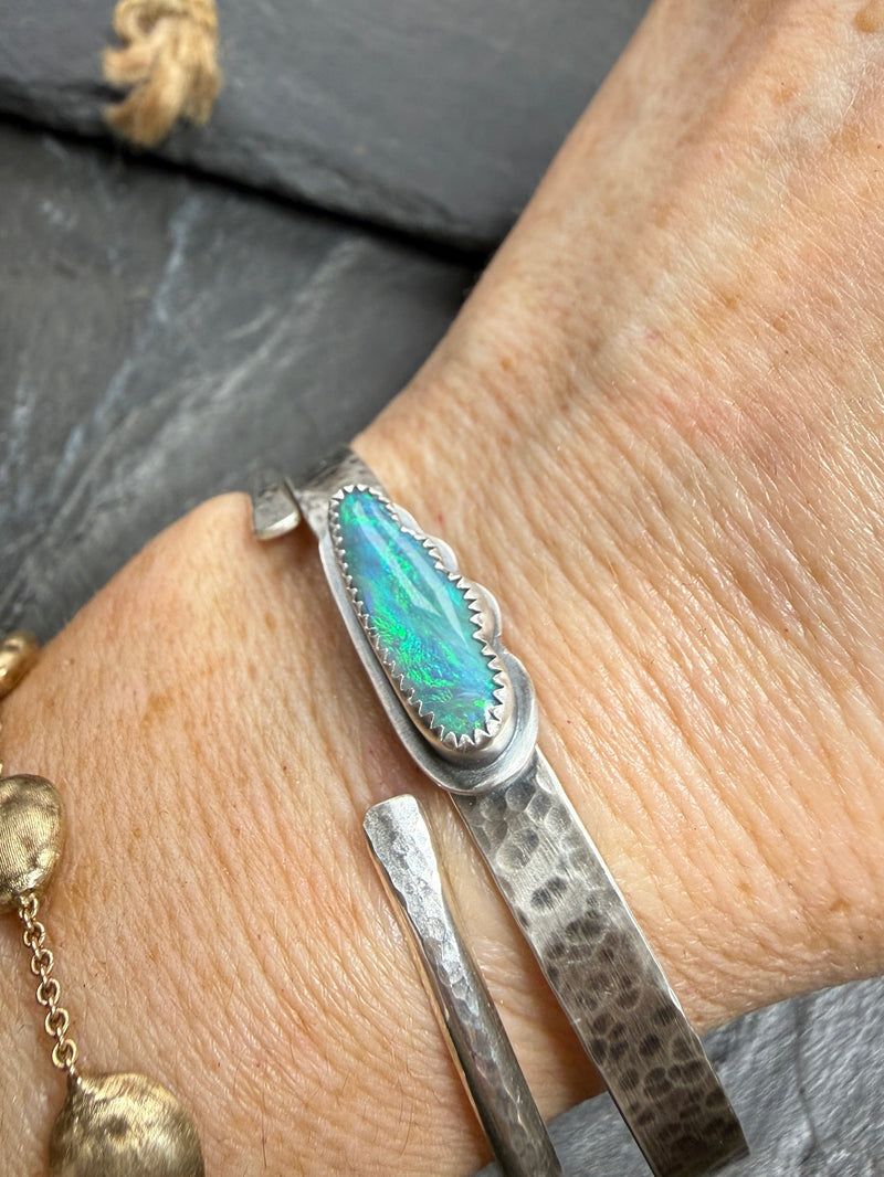 Hammered silver cuff bangle with a cloud shaped boulder opal
