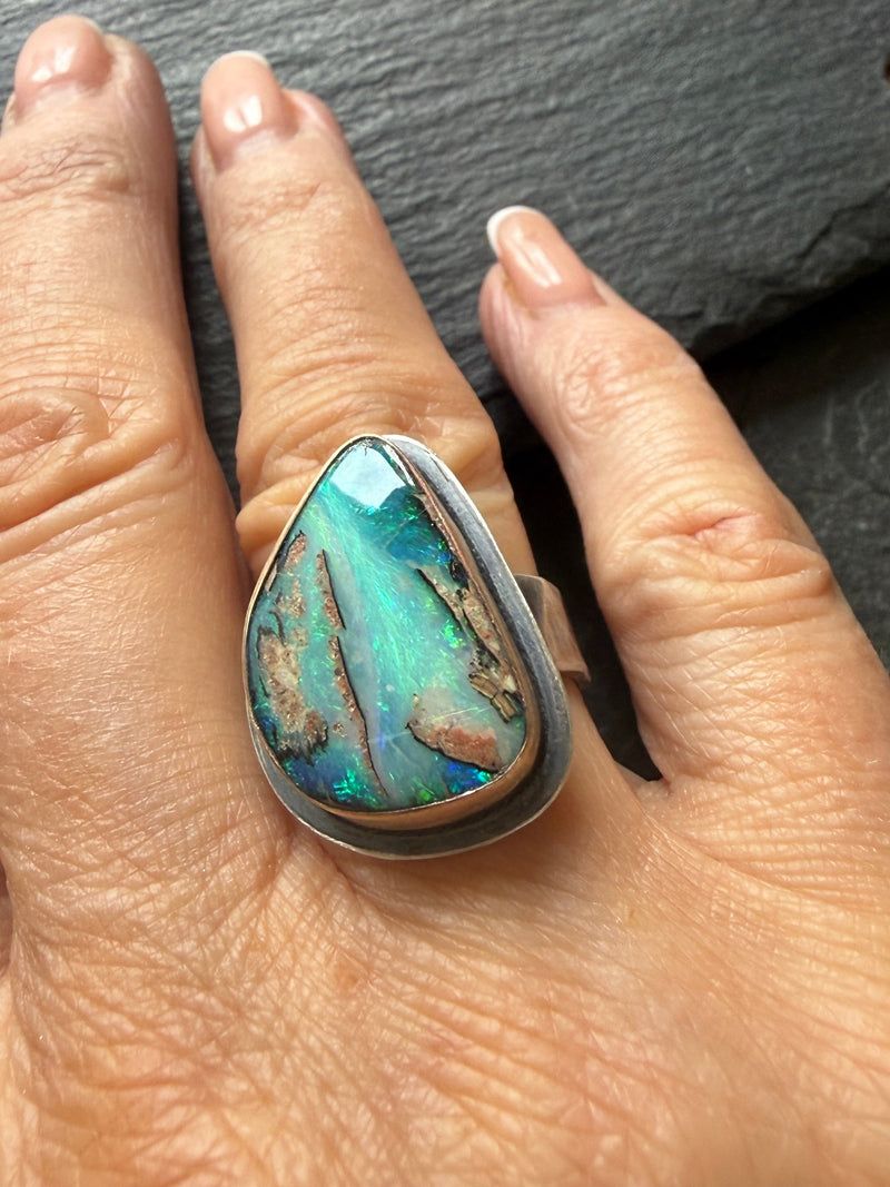 Large boulder opal statement ring worn on a hand